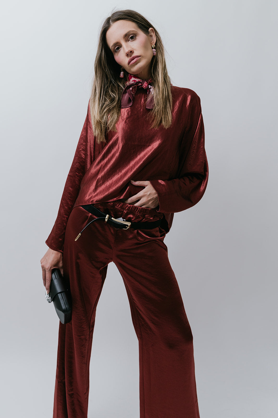 Woman wearing a burgundy satin outfit