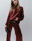 Woman wearing a burgundy satin outfit