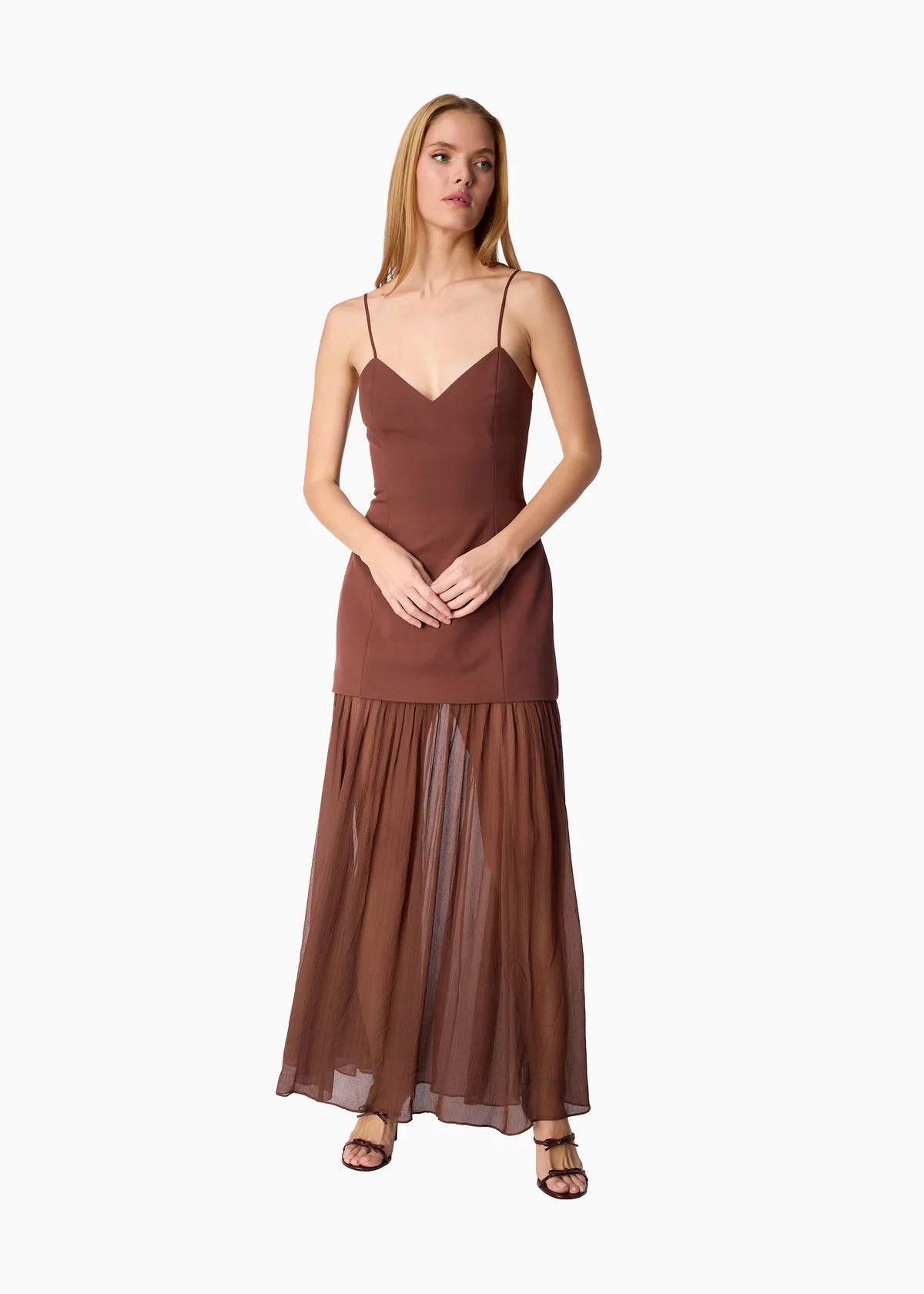 model wearing a brown dress on a white background