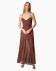 model wearing a brown dress on a white background