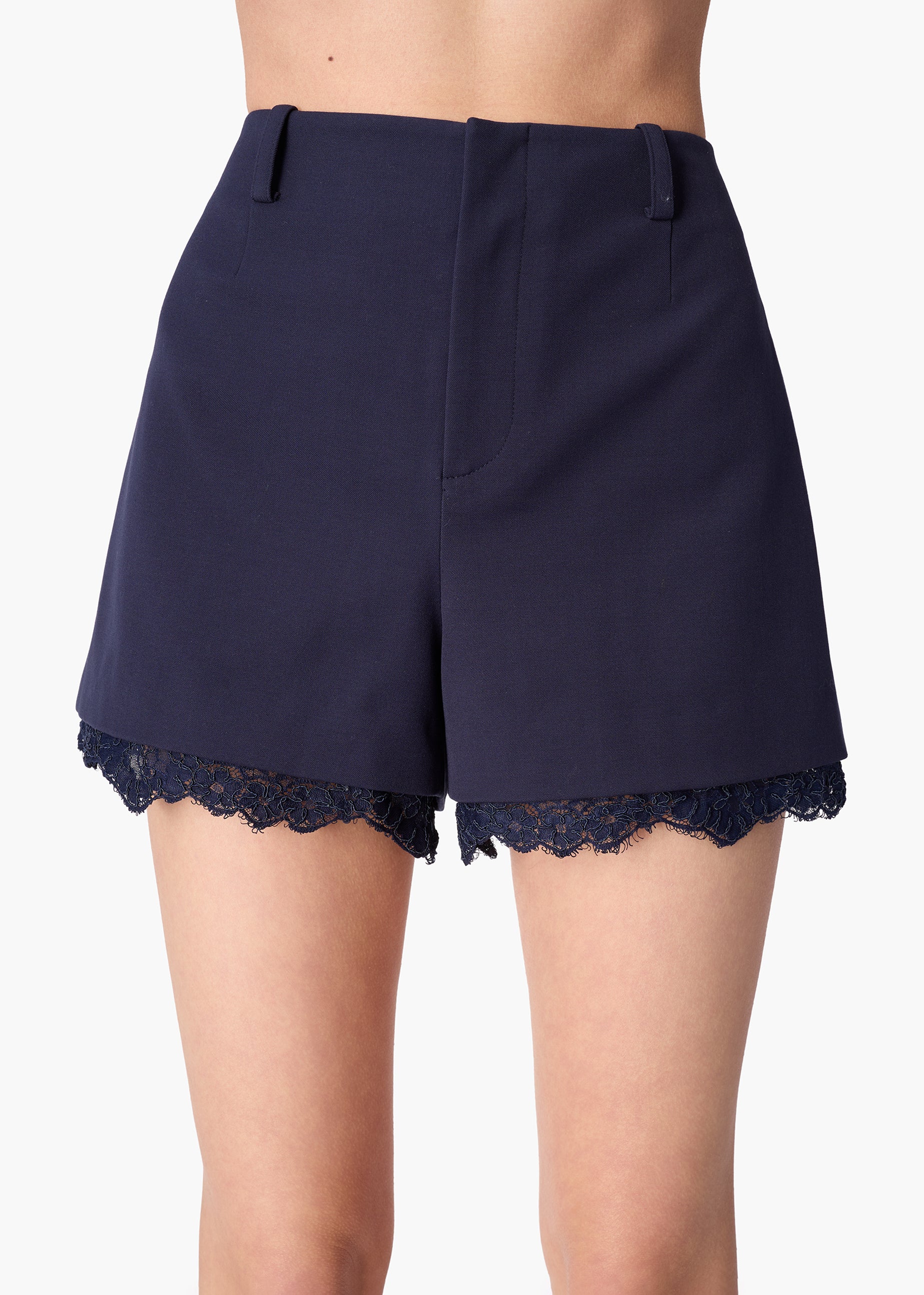 Navy blue shorts with lace trim on a white background