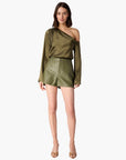 Woman wearing an olive green off-shoulder top and skirt on a white background