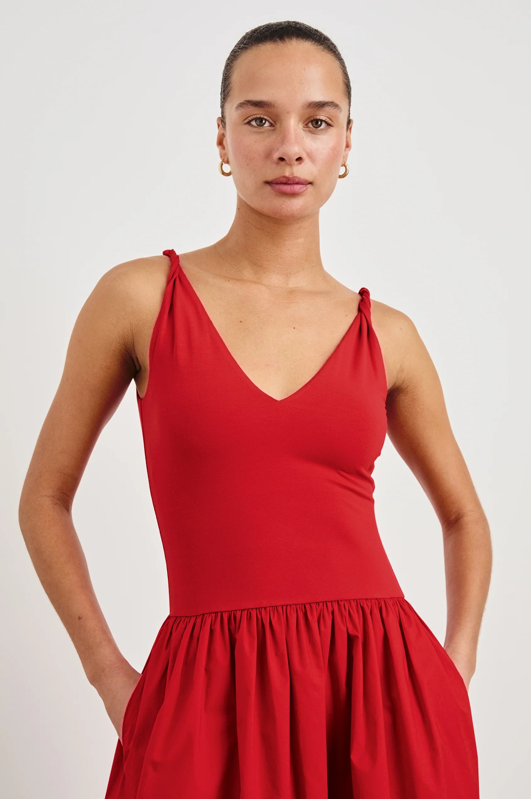 Woman wearing a red dress against a white background front view