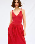 Woman wearing a red dress on a white background front view