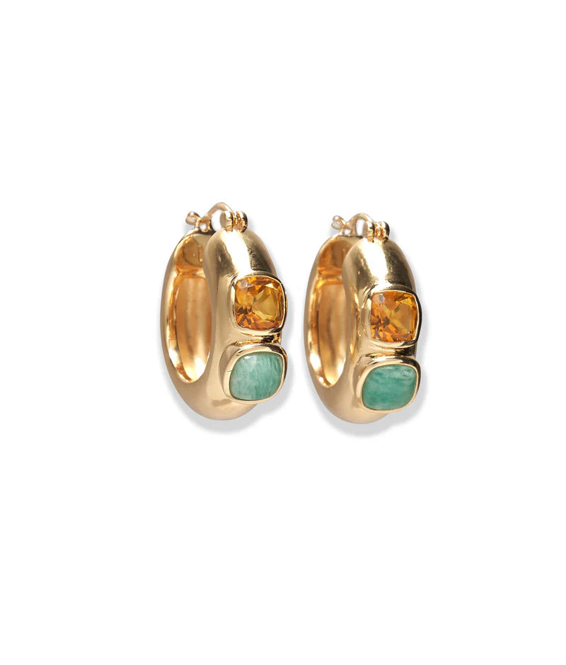 Gold hoop earrings with embedded stones on a white background