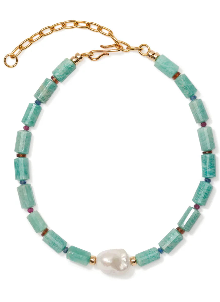 Necklace with turquoise beads and a pearl on a white background