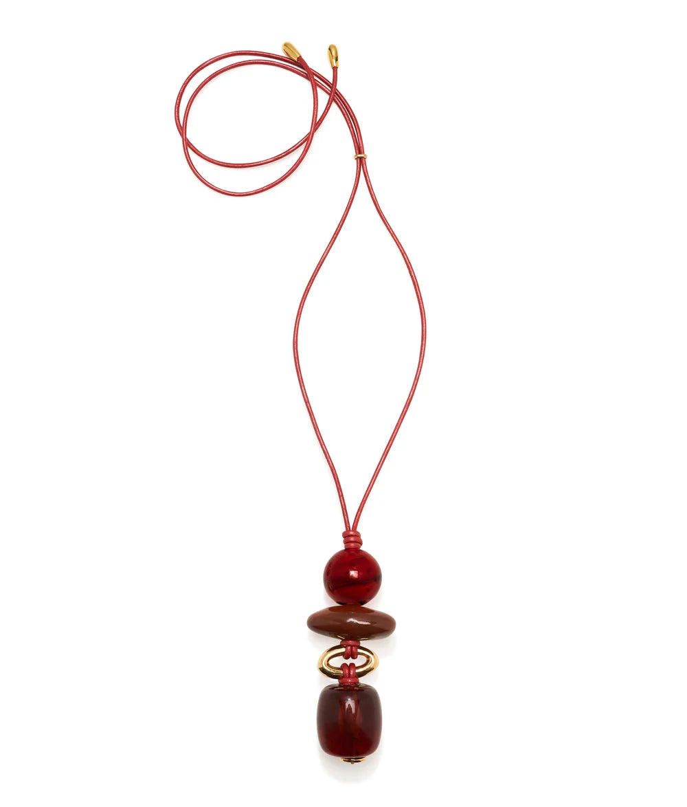 A red cord necklace featuring a stack of polished dark red and brown beads with small gold-toned spacer rings, displayed on a clean white background.
