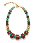 A statement beaded necklace featuring large terracotta brown cylindrical beads, small turquoise green beads, and alternating dark brown and light gray striped spacer beads, finished with gold-toned metal spacers and a gold clasp chain.