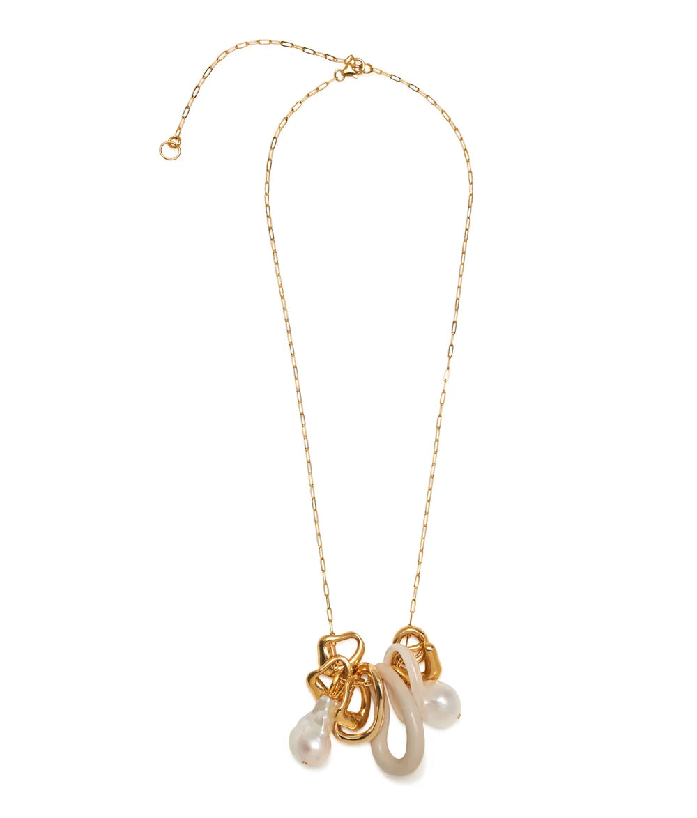 A gold chain necklace featuring a multi-strand pendant with white faux pearls and a translucent white stone, set against a plain white background.