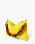 Yellow handbag with a large brown chain handle on a white background