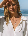 Finn Paperclip Charm Necklace with fish and pearl charms on it
