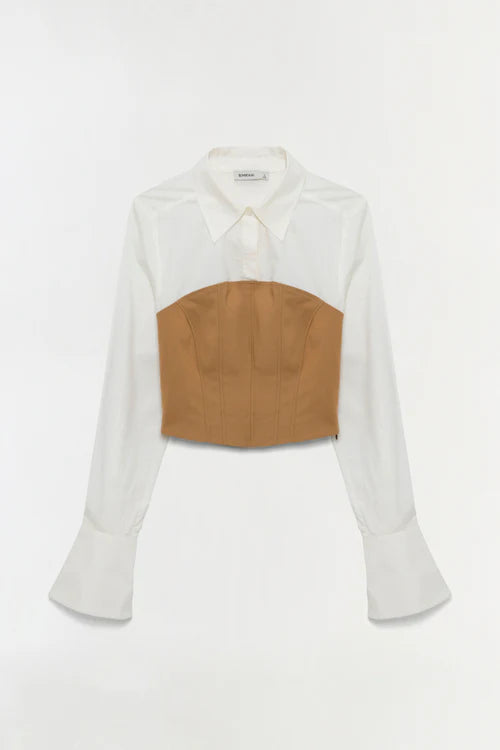 White blouse with a brown leather patch on a white background