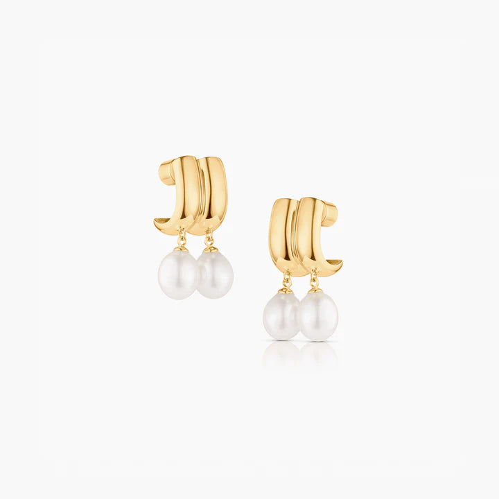 Gold hoop earrings with pearl drops on a white background