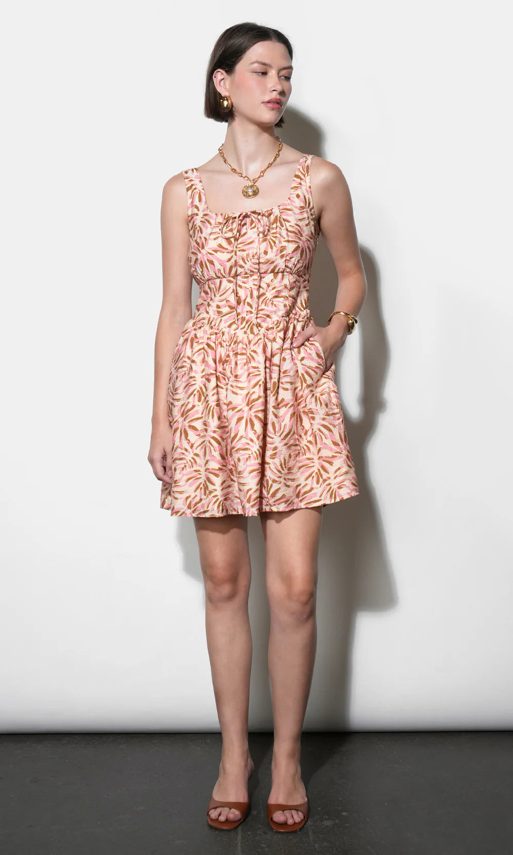 Woman wearing a floral dress against a white background