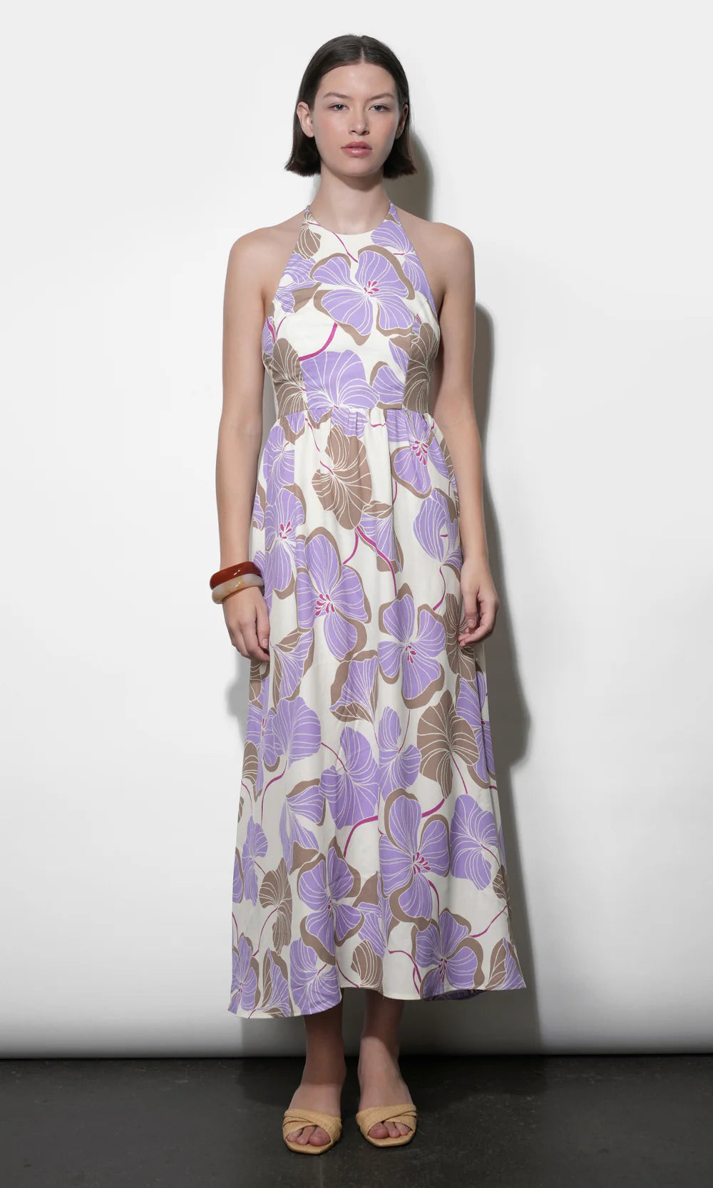 Woman wearing a floral dress with a white background