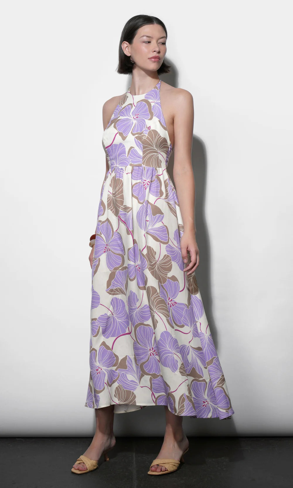 Woman wearing a floral dress with a white background