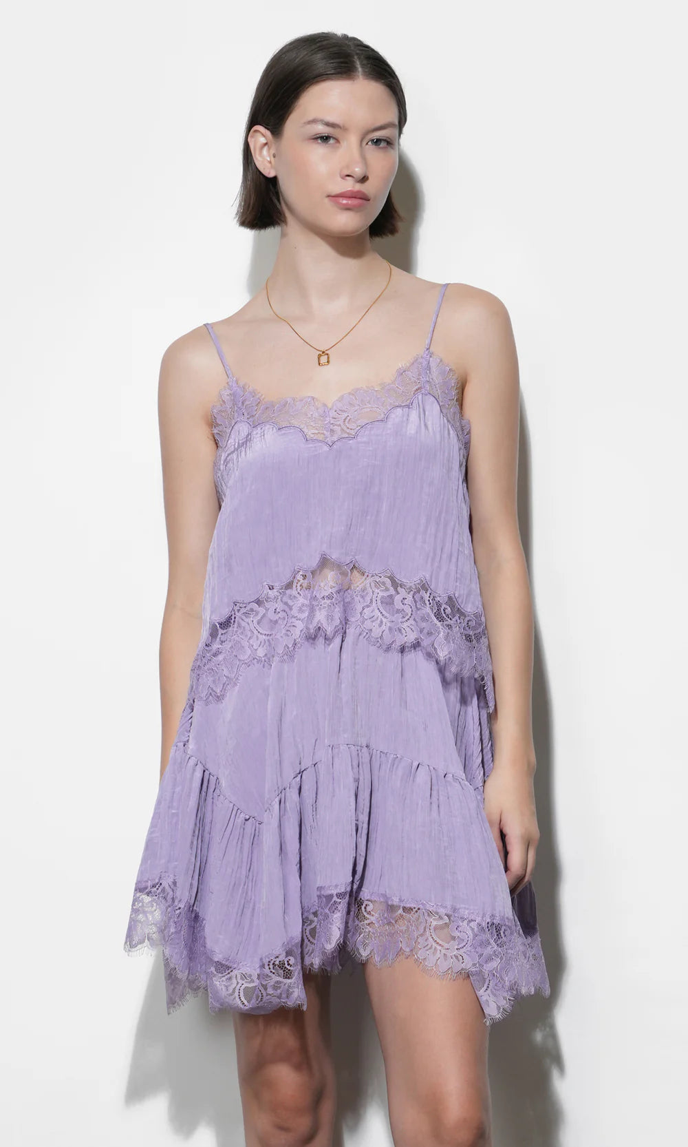 Woman wearing a purple lace set against a white background