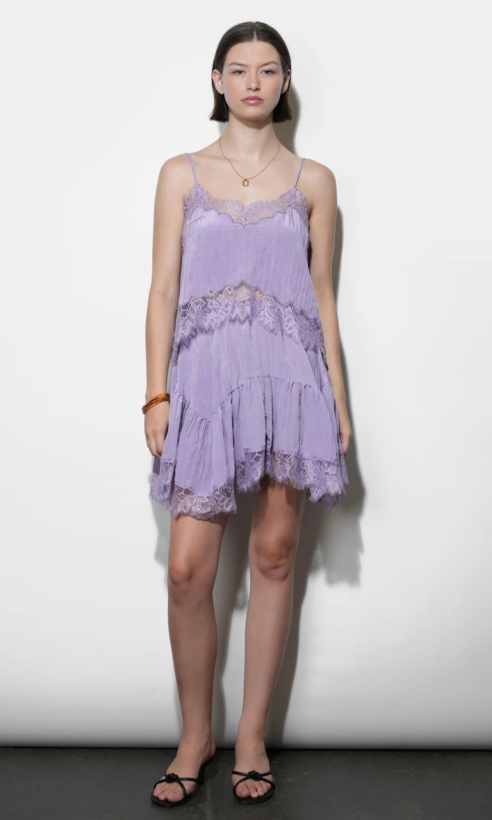 Woman wearing a purple lace set against a white background