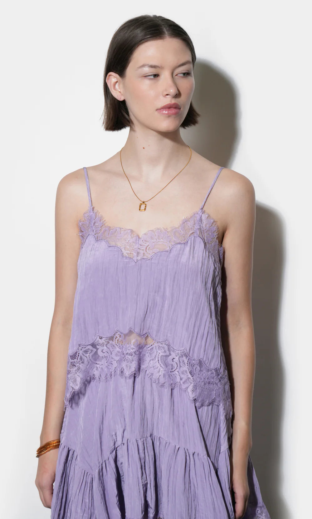 Woman wearing a purple lace set against a white background