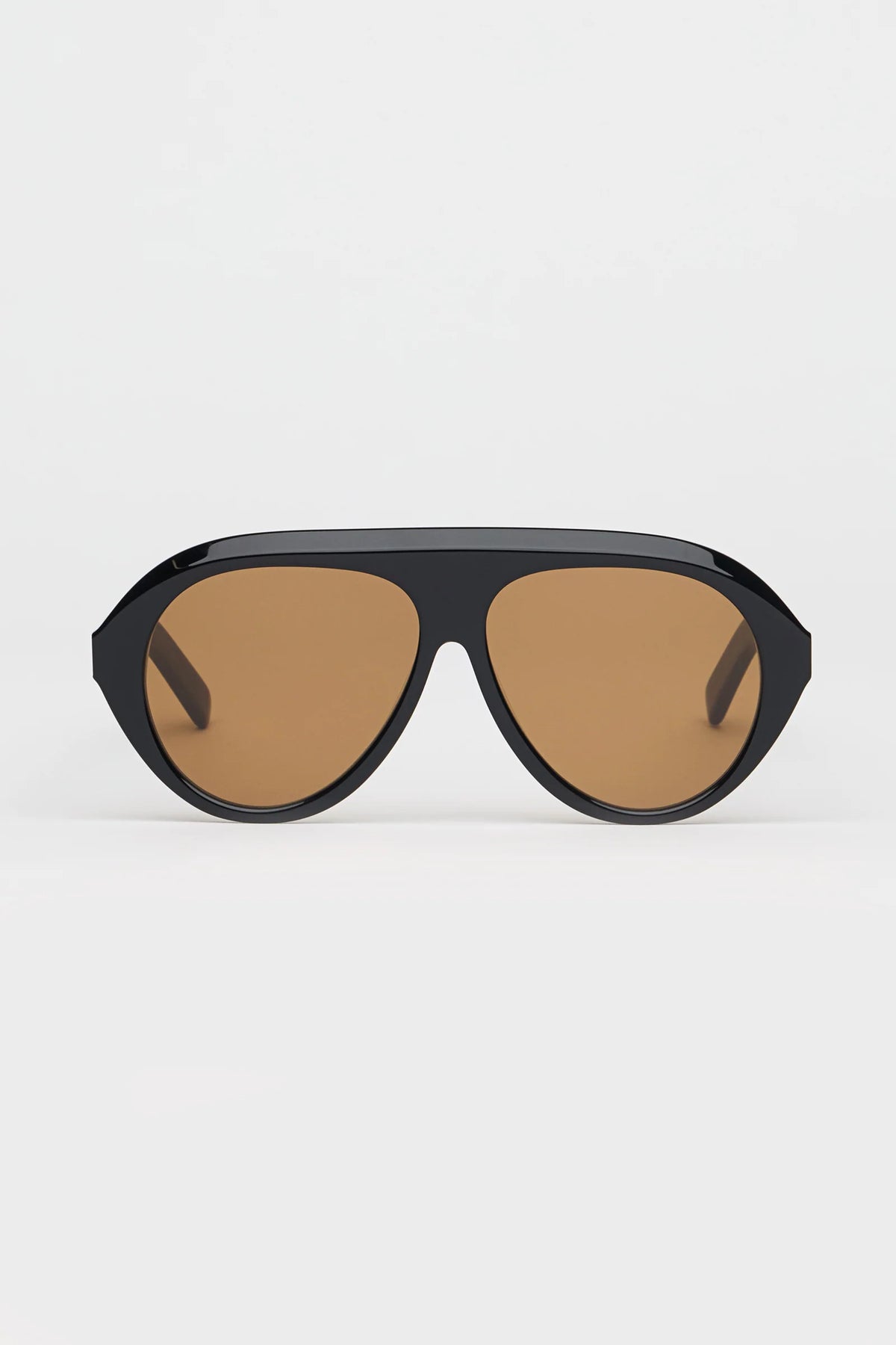 Sunglasses with brown lenses and black frame on a white background