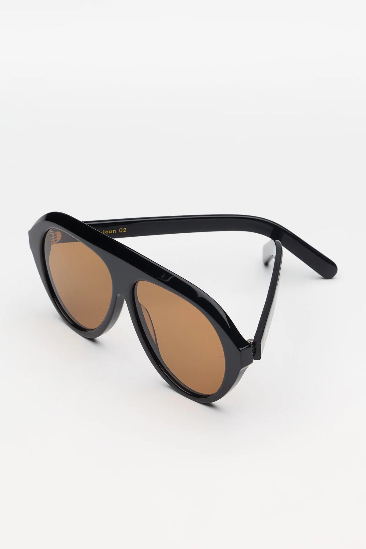 Black sunglasses with brown lenses on a white background