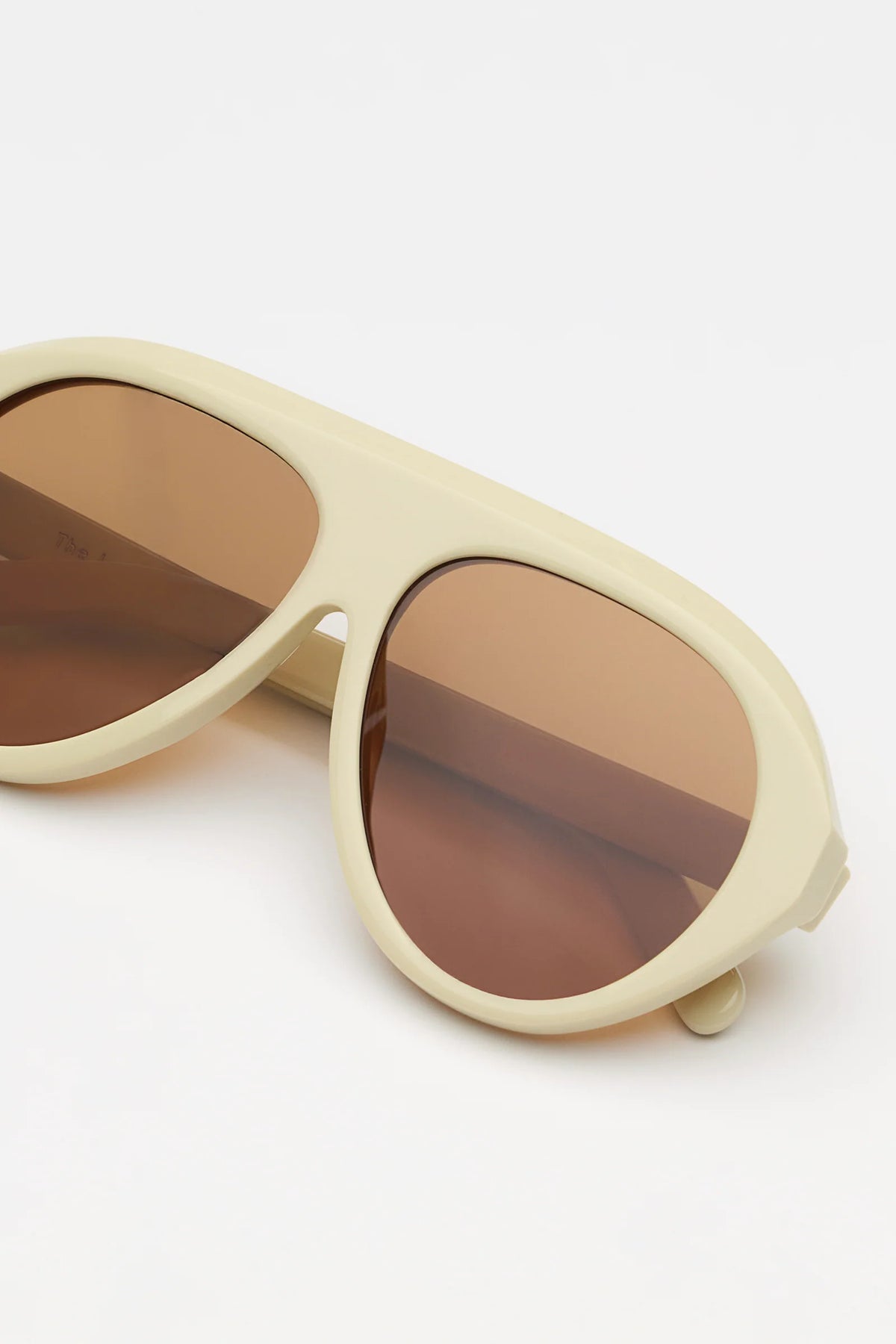 ivory sunglasses with amber lenses on a white background 