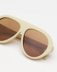 ivory sunglasses with amber lenses on a white background 