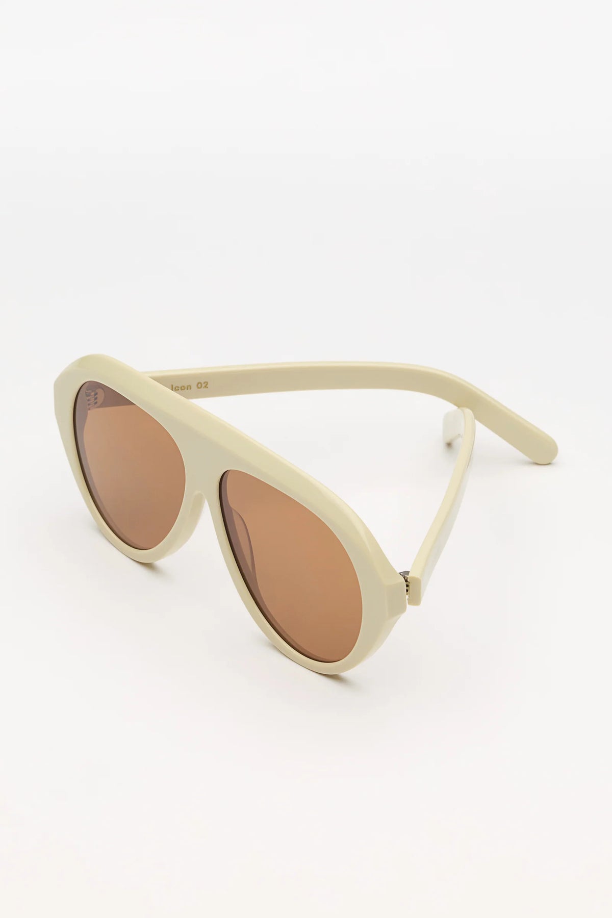 ivory sunglasses with amber lenses on a white background 