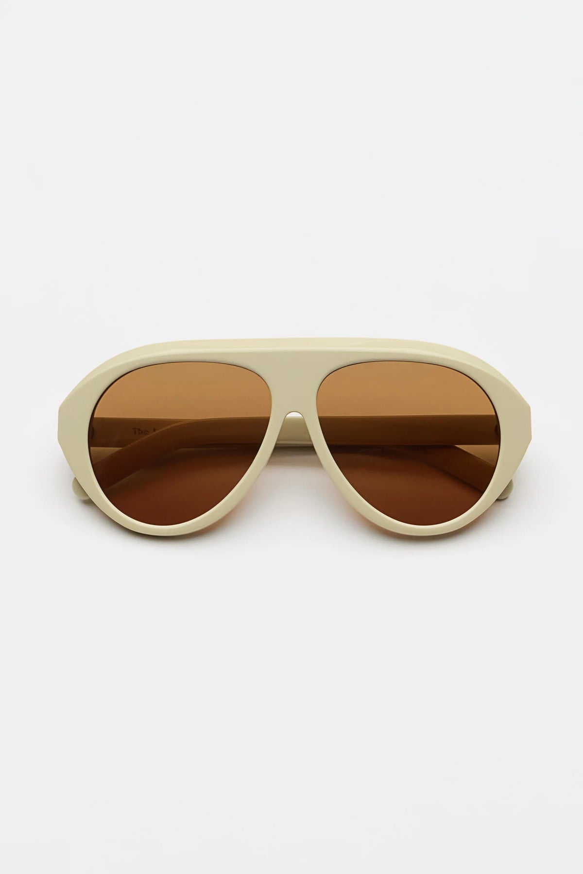 ivory sunglasses with amber lenses on a white background 