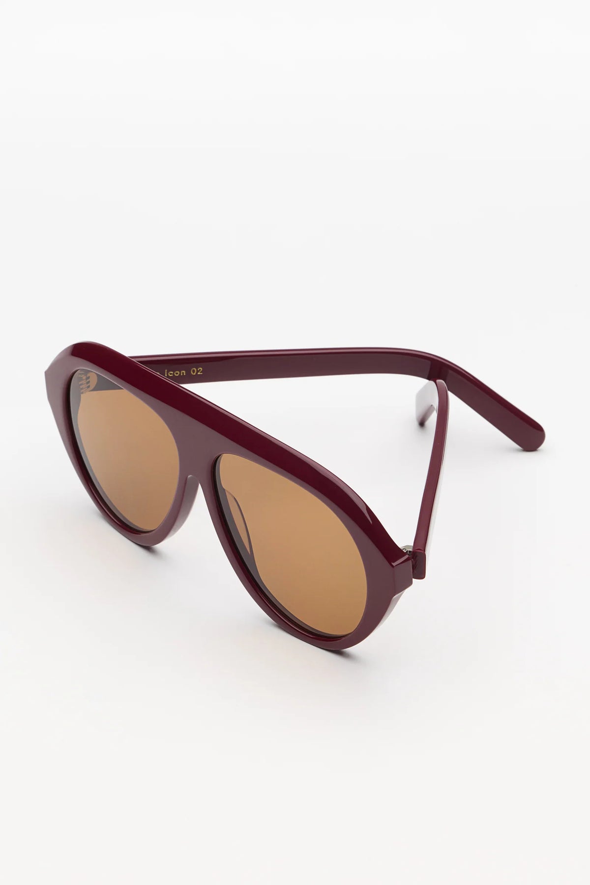 garnet oversized sunglasses with amber lenses on a white background 