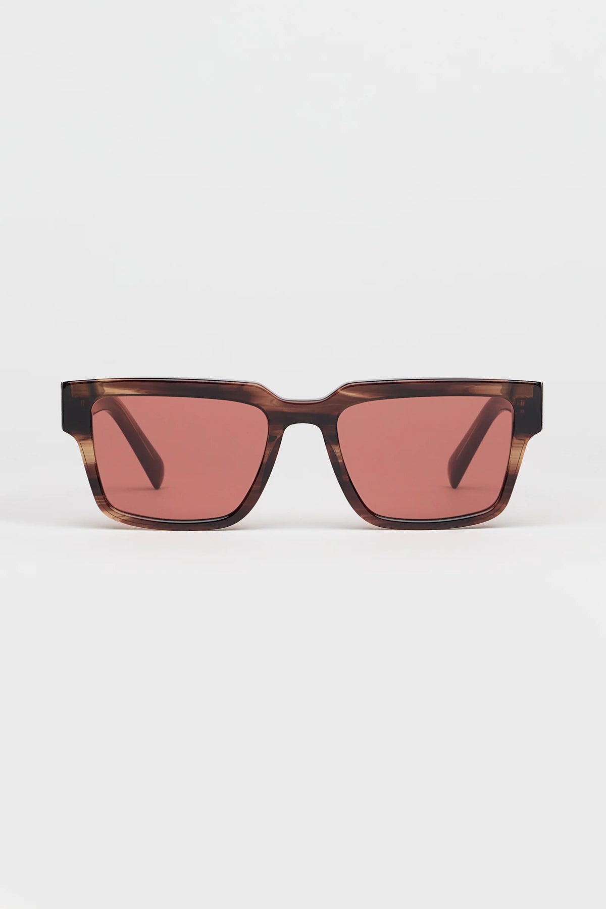 Square sunglasses with a translucent redish brown tortoiseshell frame and light red lenses, shown against a plain light gray background.