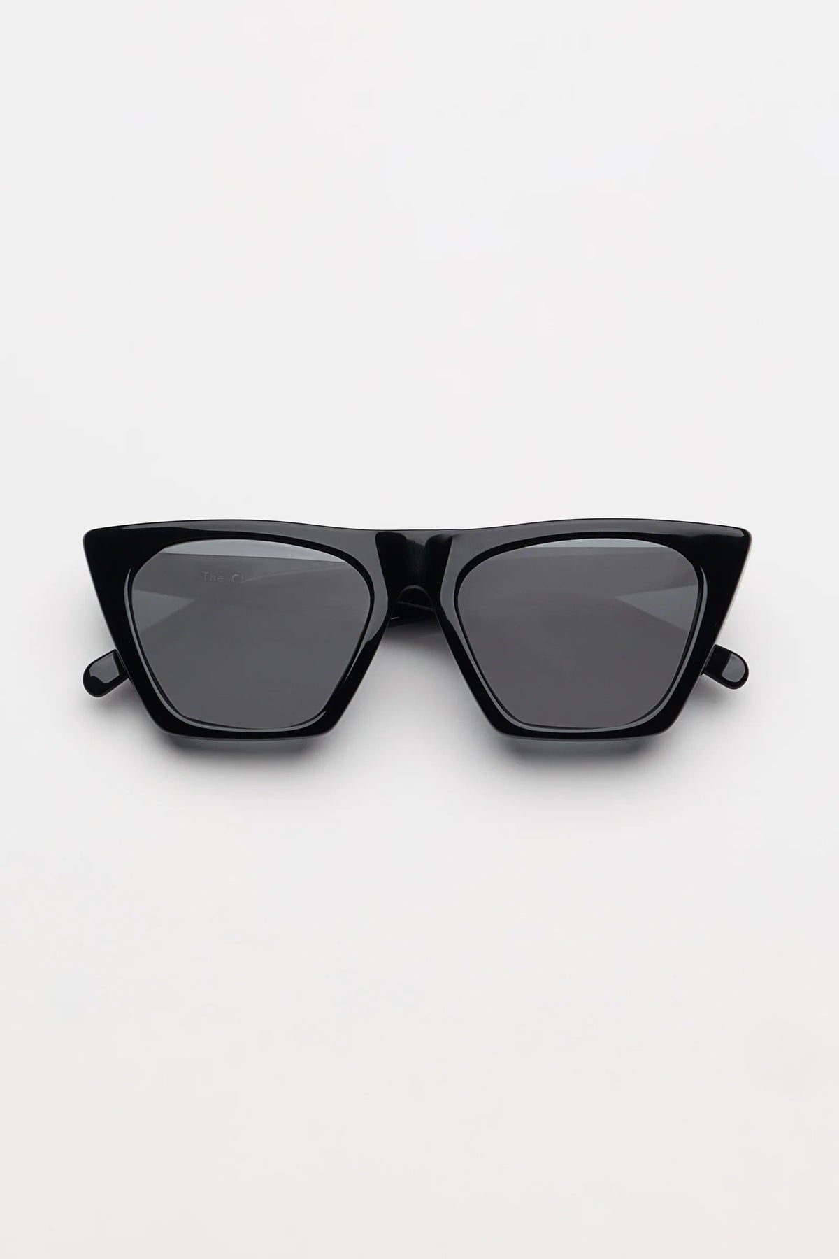 black sunglasses folded on a white background