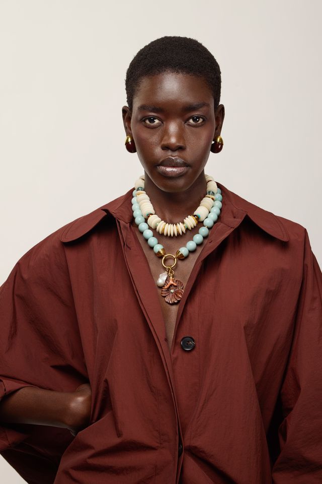 Toro Earrings in Aubergine on model with red coat