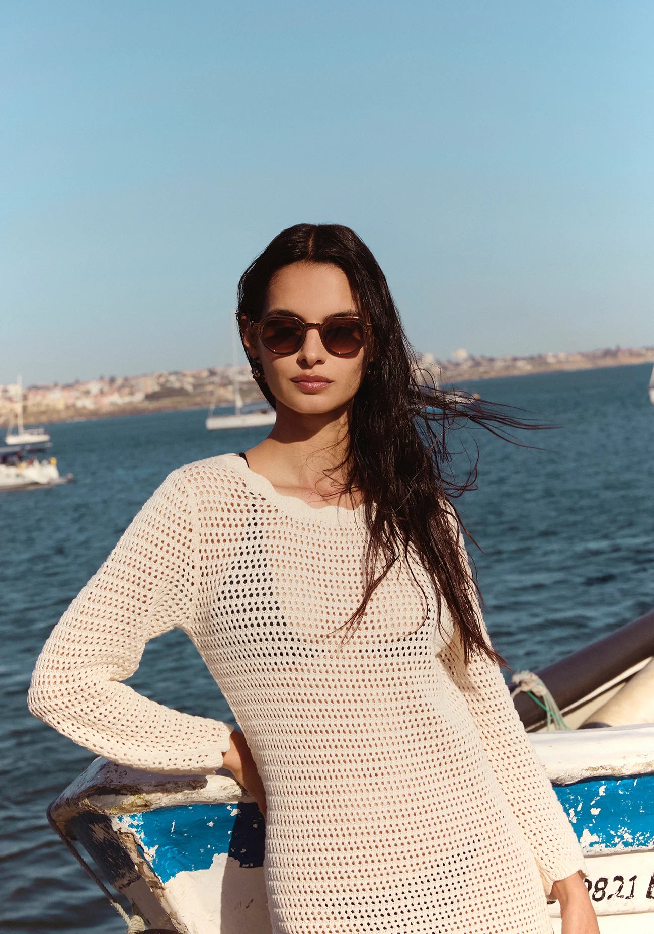 Galvan Sunglasses Bronze Chroma + Venezia on model with average, square face shape, standing by a boat