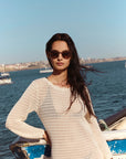 Galvan Sunglasses Bronze Chroma + Venezia on model with average, square face shape, standing by a boat
