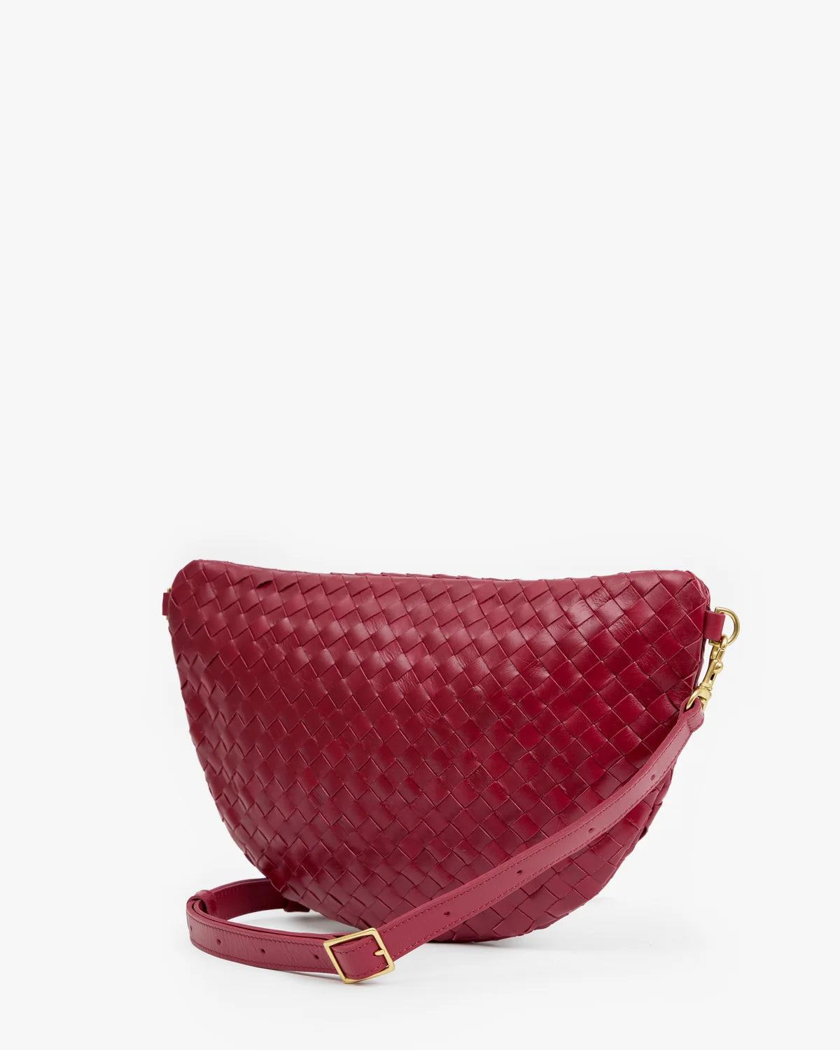 A woven leather crescent-shaped shoulder bag in deep burgundy red, featuring a matching leather strap with gold-tone hardware, set against a plain white background.