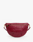 A burgundy woven leather half-moon waist bag with gold-tone hardware and a zippered front, shown against a plain white background.