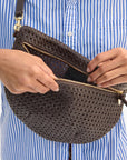 Grande Fanny in Chocolate Rattan close up front view on model opening bag