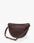 A dark brown woven leather crescent-shaped shoulder bag with a matching adjustable strap and gold-tone hardware, photographed on a clean white background.