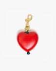 Red heart-shaped charm with gold clasp on a white background
