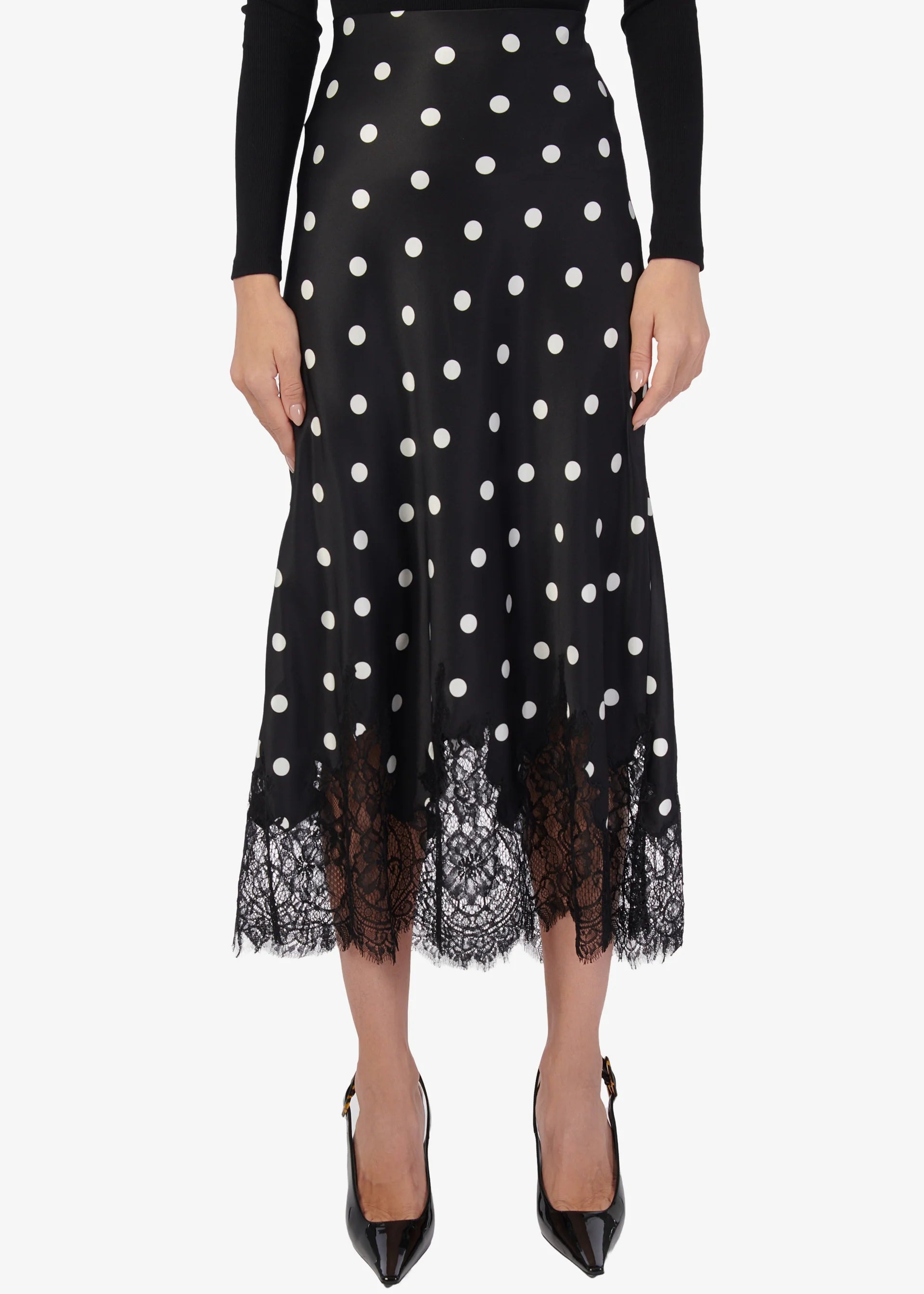 Black polka dot skirt with lace trim on a white background