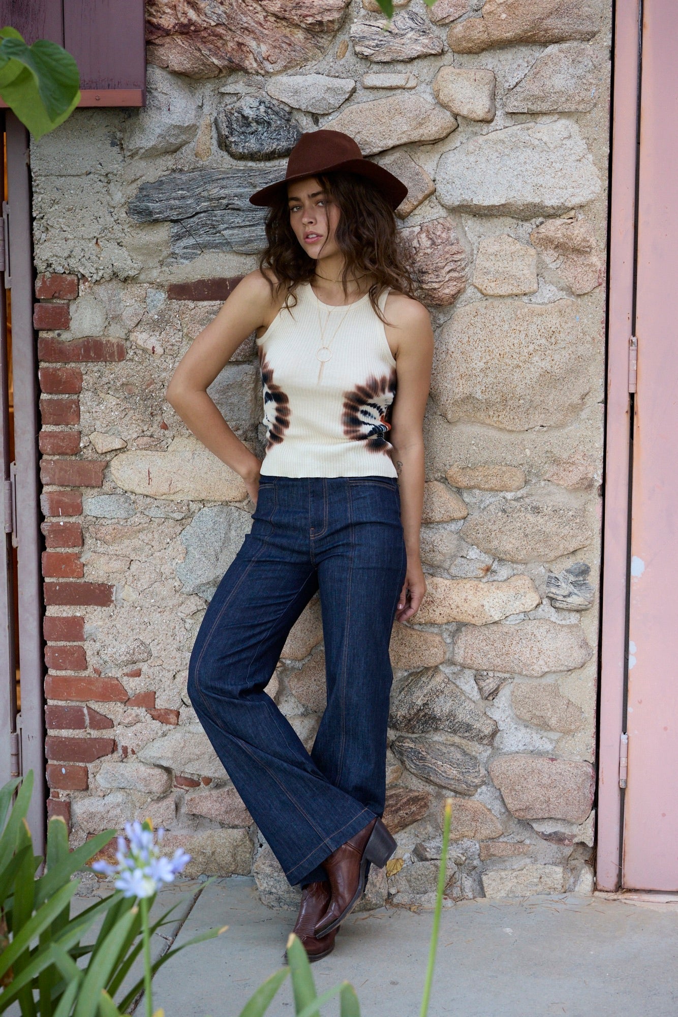 Meero Straight Leg Jean front view with model leaning against stone wall