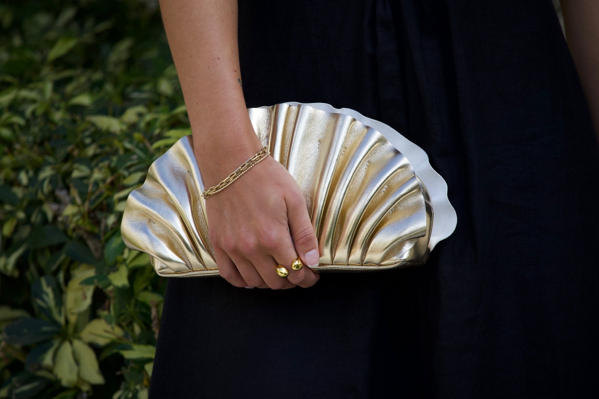 Hollie Pleated Clutch close up, held by model