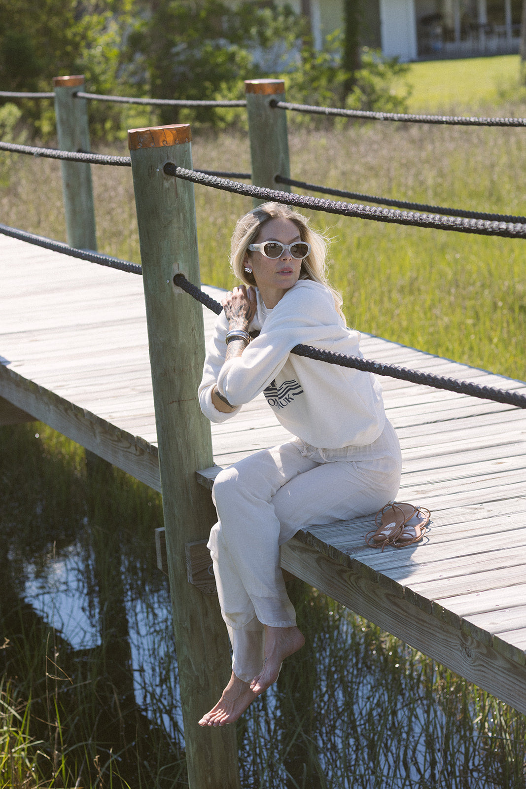 Strada Pants model sitting on edge of dock