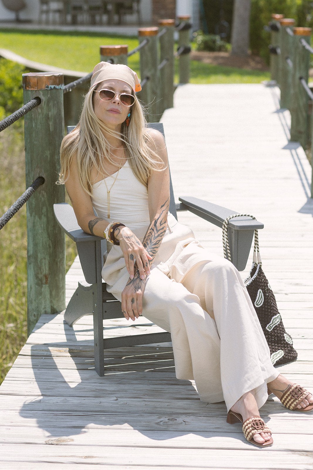 Woman in Ramsey Linen Wide Leg Pant sitting on a wooden bench outdoors