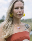 Mich Necklace with strapless dress and yellow earrings