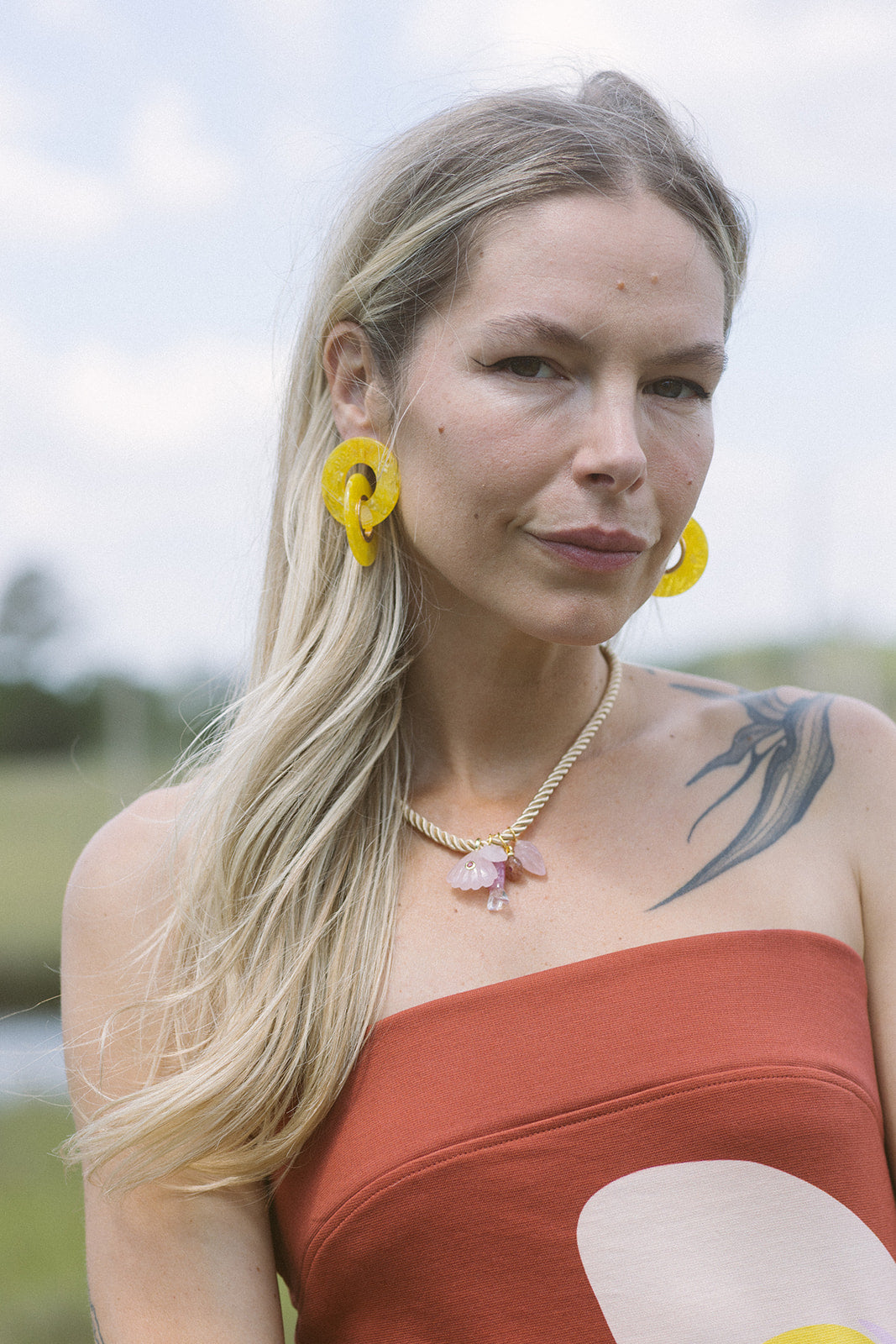 Woman with yellow earrings and Mich Necklace