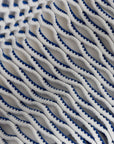 Close-up of a textured fabric with blue and white pattern