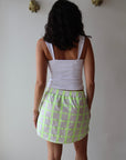 The Boxer Mini Skirt in Dayglow back view on model