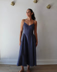 Bardot Dress in Navy full body front view on model with hands to side